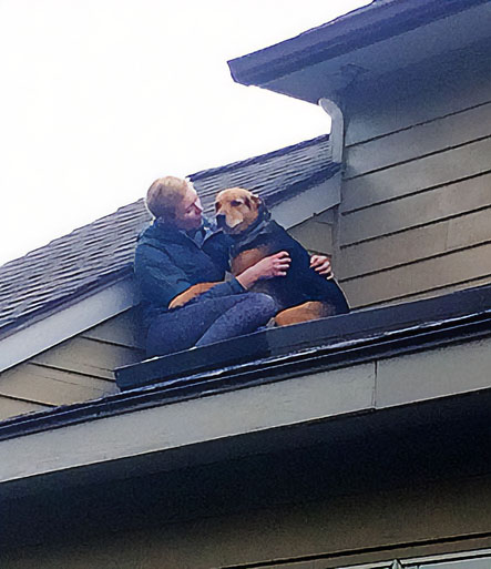 man and dog on roof top