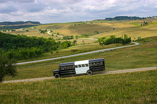BueLingo Tour bus from Longhorn Head to Tail tours with visitor at Dickinson Cattle Co.