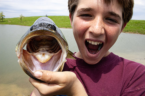 Boy with large mouth bass
