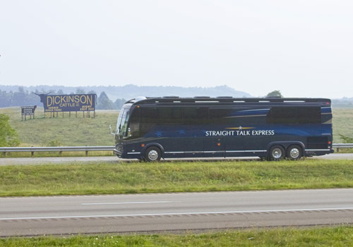 Sarah Palin and John McCain on campaign bus looking at ranch billboard