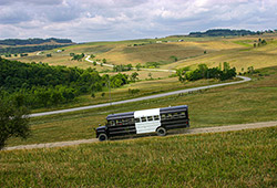 BueLingo Tour bus from Longhorn Head to Tail tours with visitor at Dickinson Cattle Co.